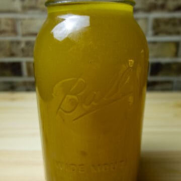Mason jar filled with golden chicken stock