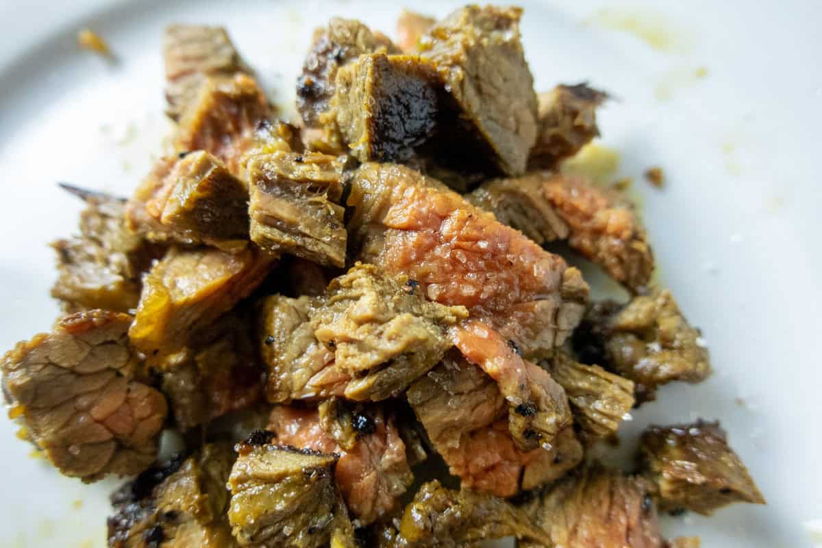 Medium rare carne asada diced into cubes.