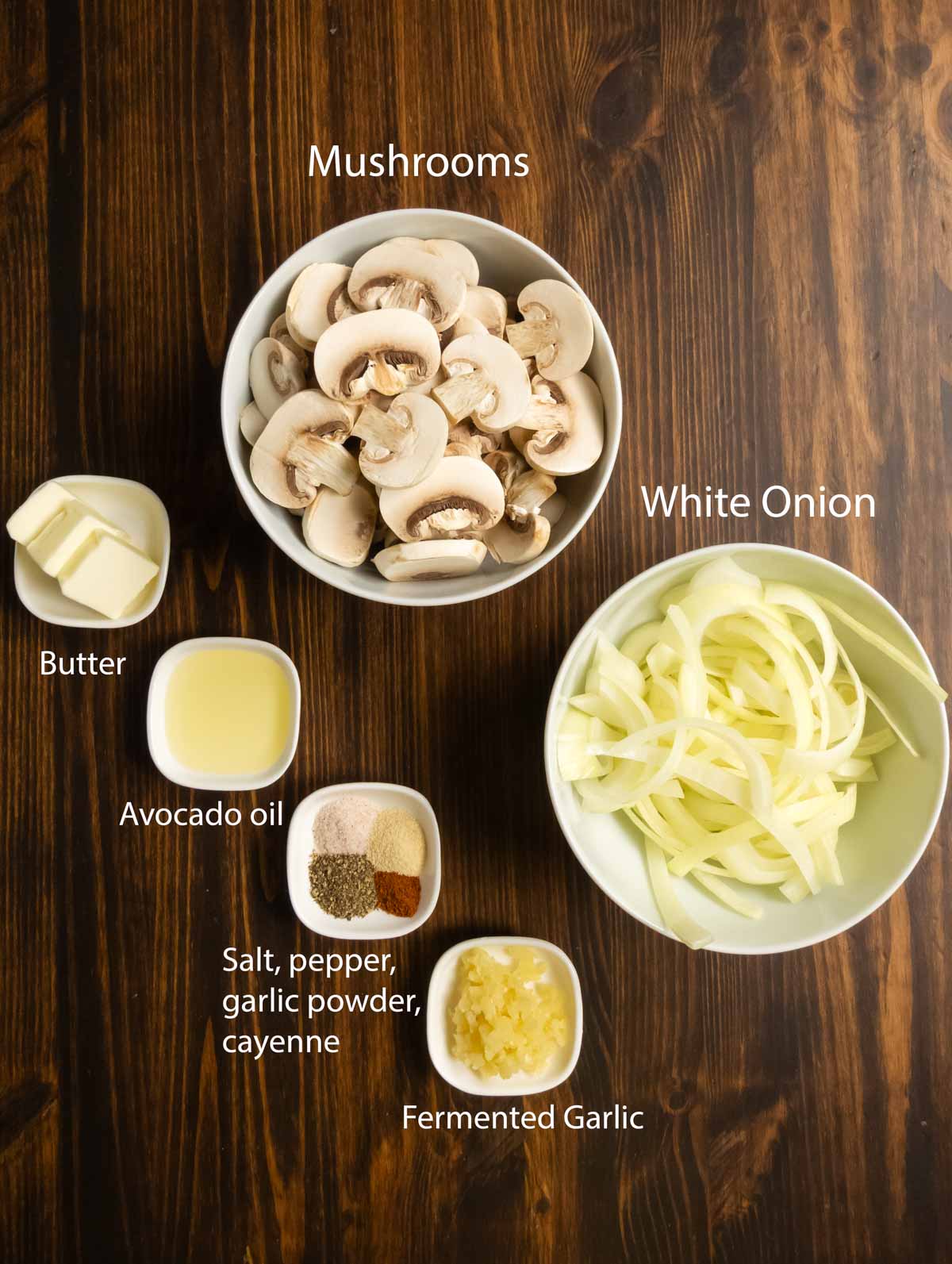 Ingredient shot with sliced mushrooms and onions, butter, oil, seasonings, and fermented garlic.