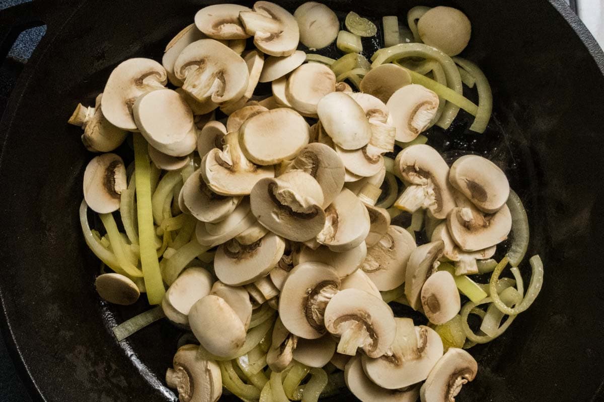 Onions cooking with mushrooms added.