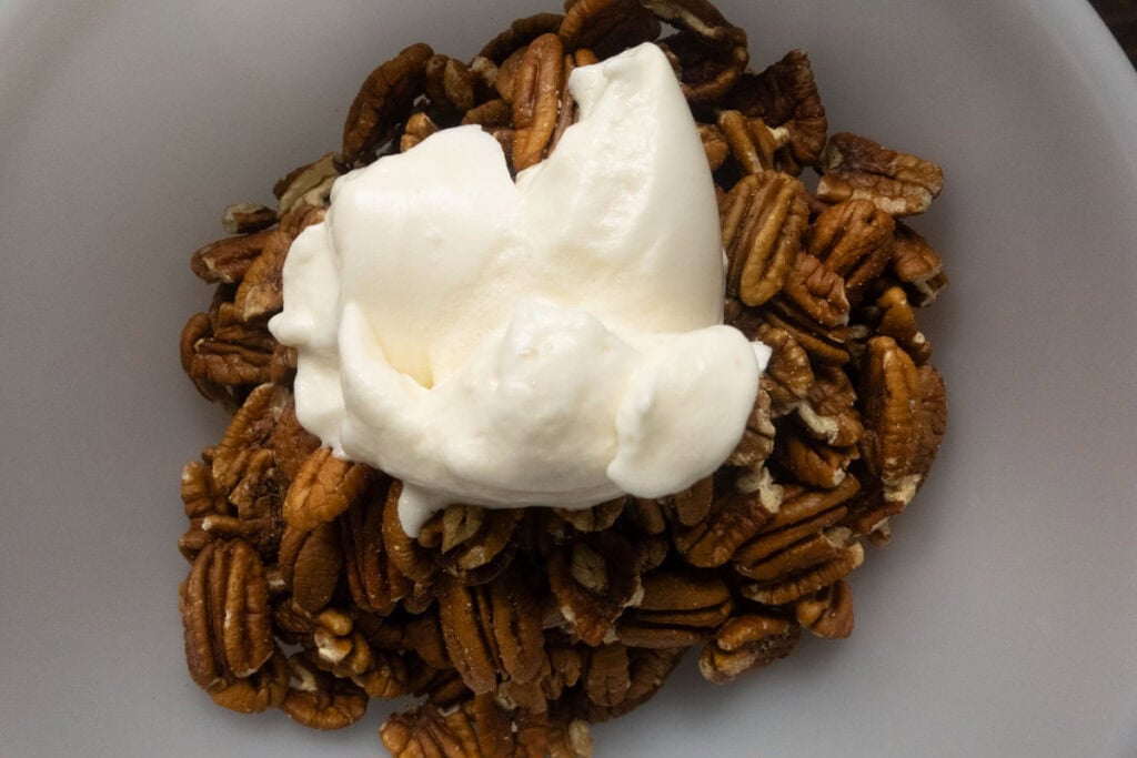 Pecans with whipped egg whites on top.