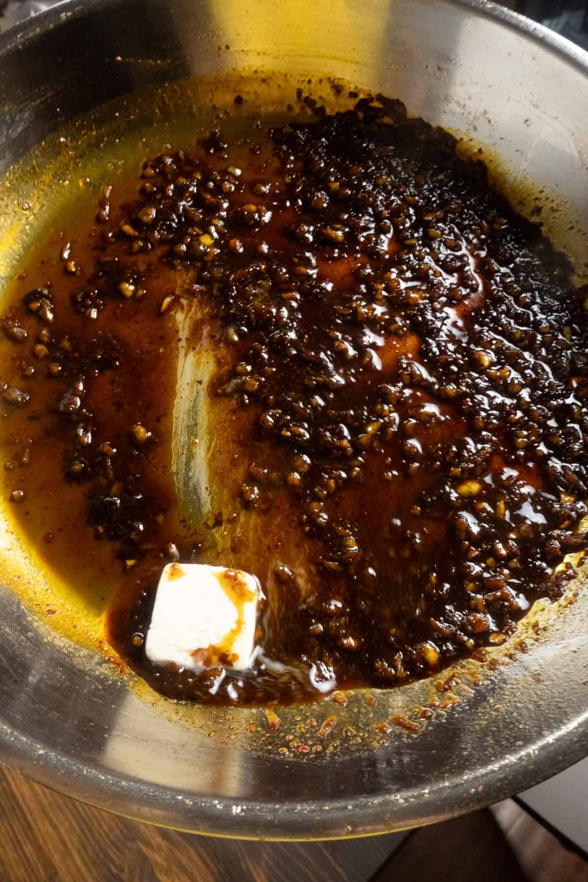 Butter sliding around the pan and infusing with the pan sauce.