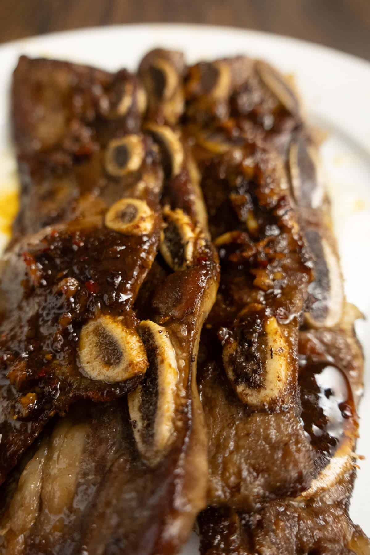Charred finished ribs on a plate.