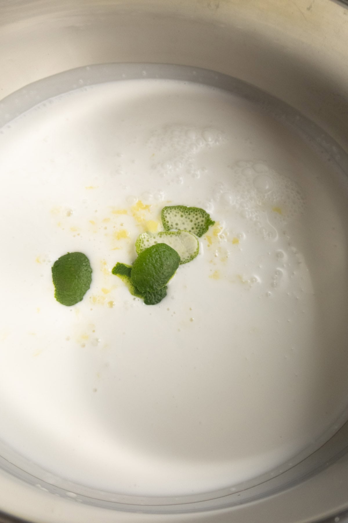 Coconut milk with ginger, garlic, and lime peel steeping.