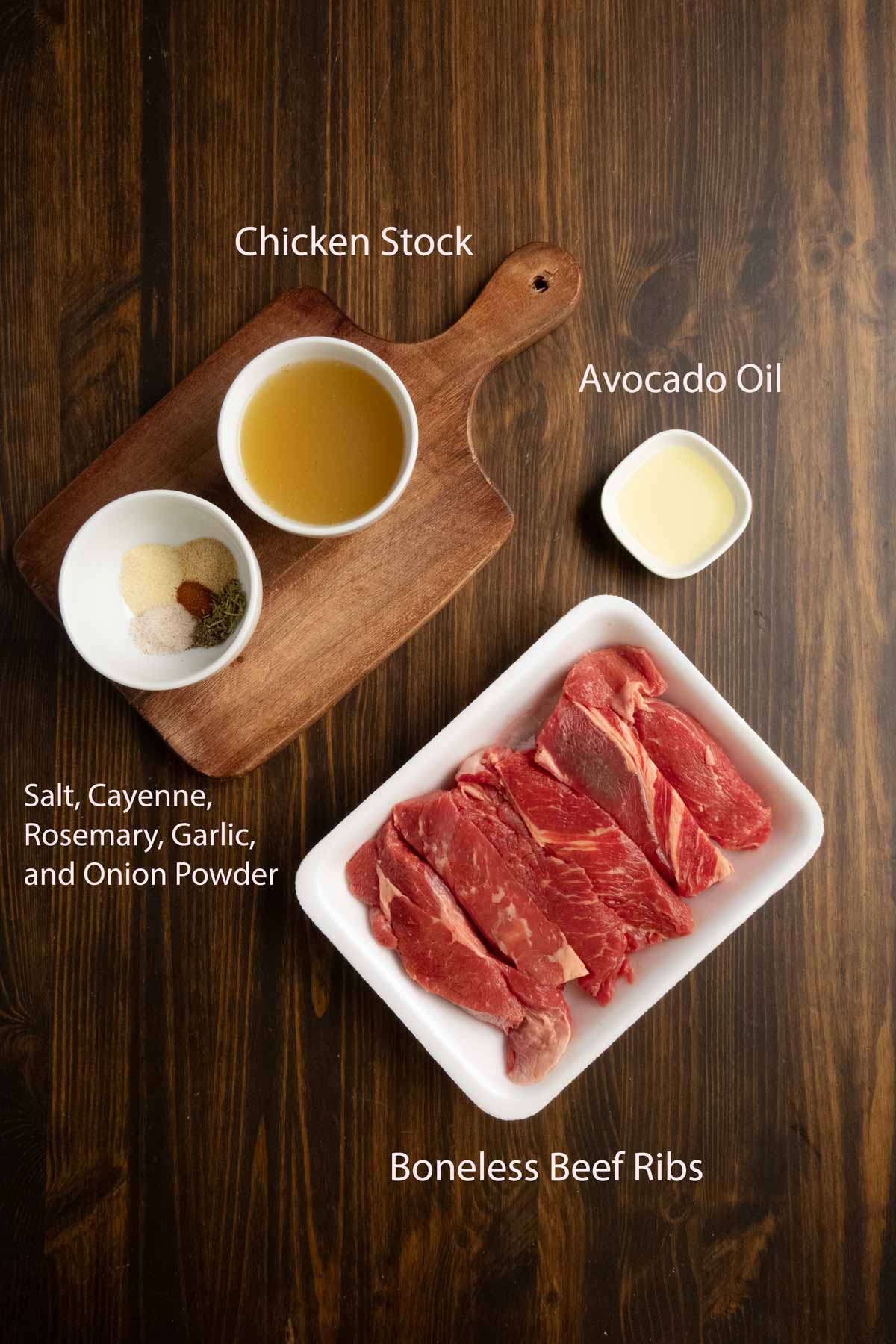 Ingredient shot of boneless beef ribs, spices, and chicken stock.