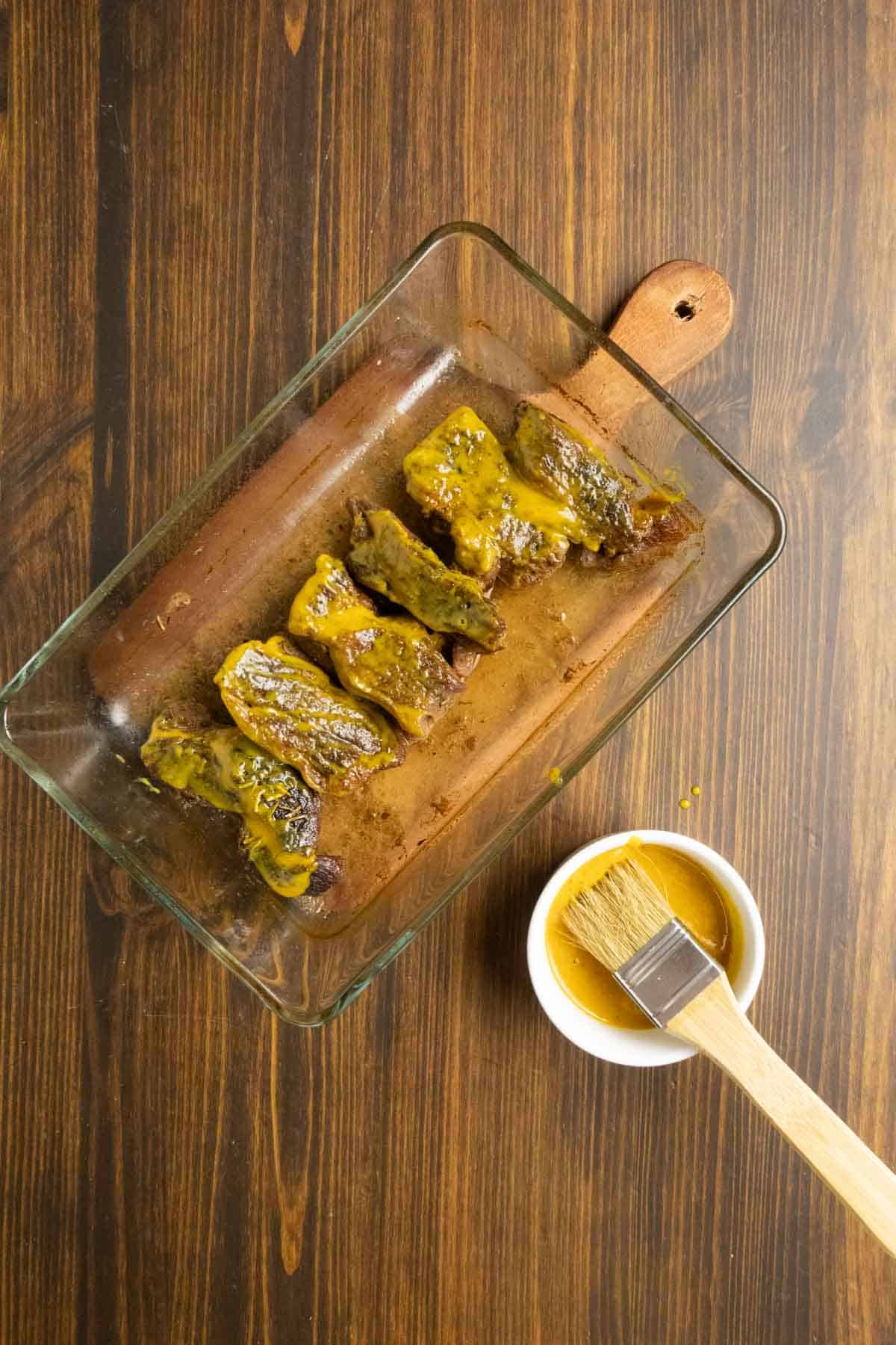 Boneless beef ribs that are almost done, but need to be cooked for thirty more minutes with the Carolina mustard sauce on them.