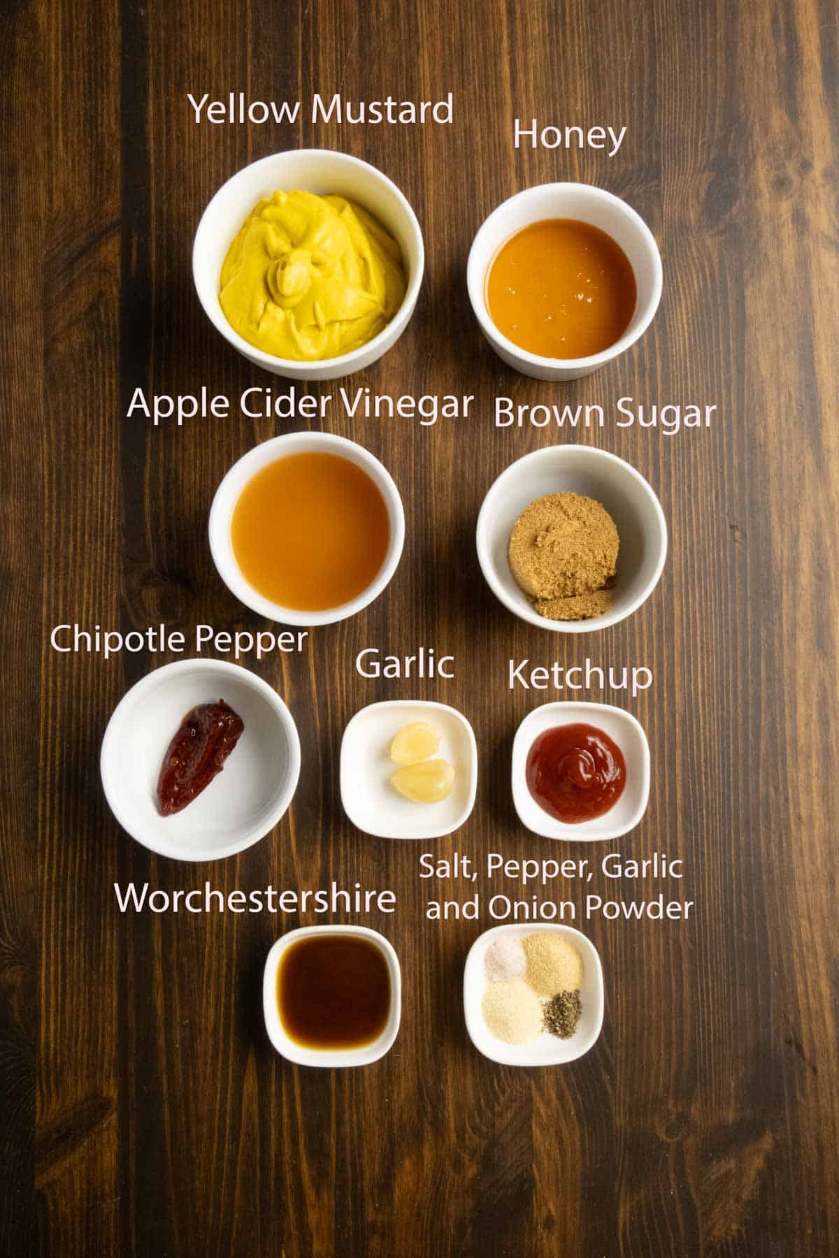 Ingredient shot of mustard, apple cider vinegar, honey, brown sugar, chipotle, and garlic.