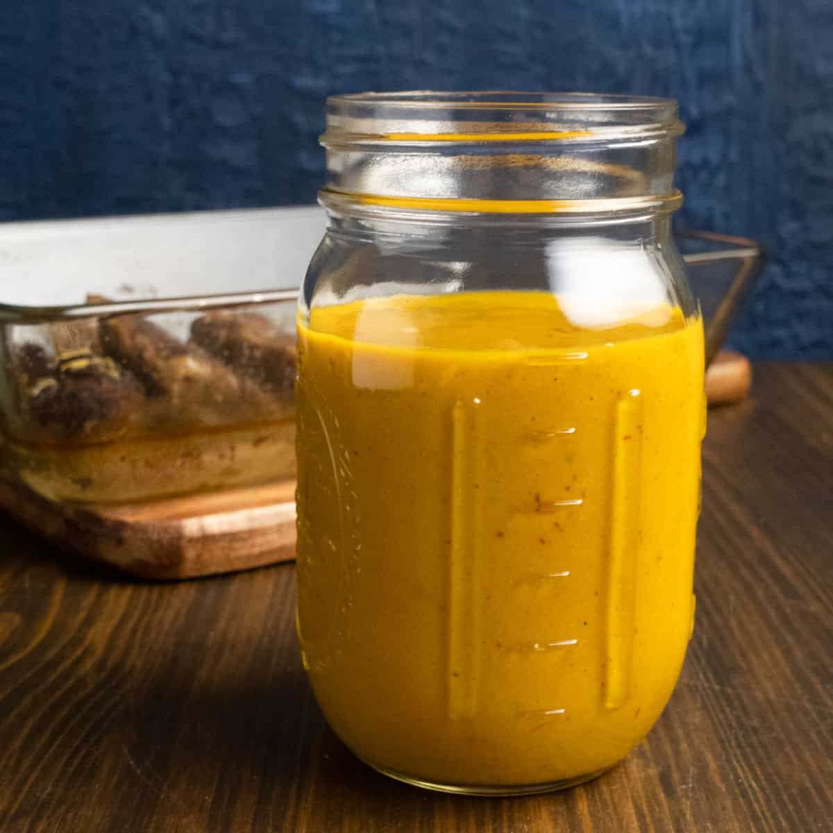 Mason jar filled with Carolina mustard BBQ sauce.
