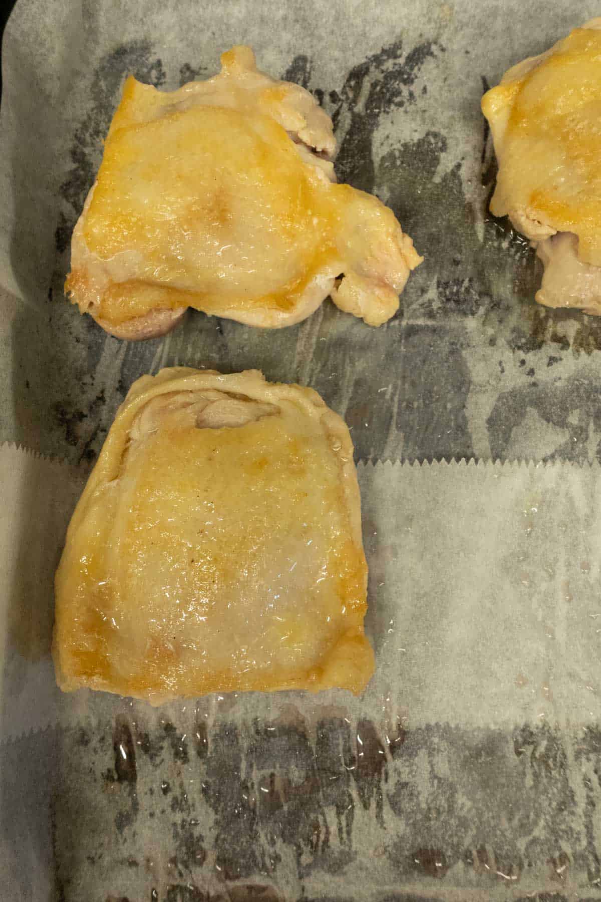 Chicken thighs after the skin is browned.