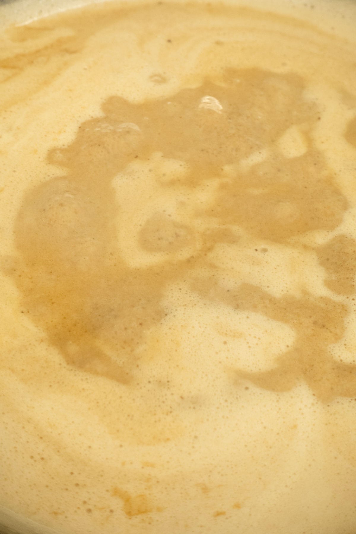 Black garlic cream starting to simmer.