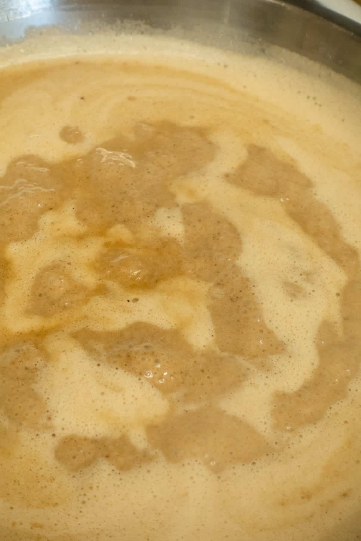 Black garlic cream thickening and getting darker in color.