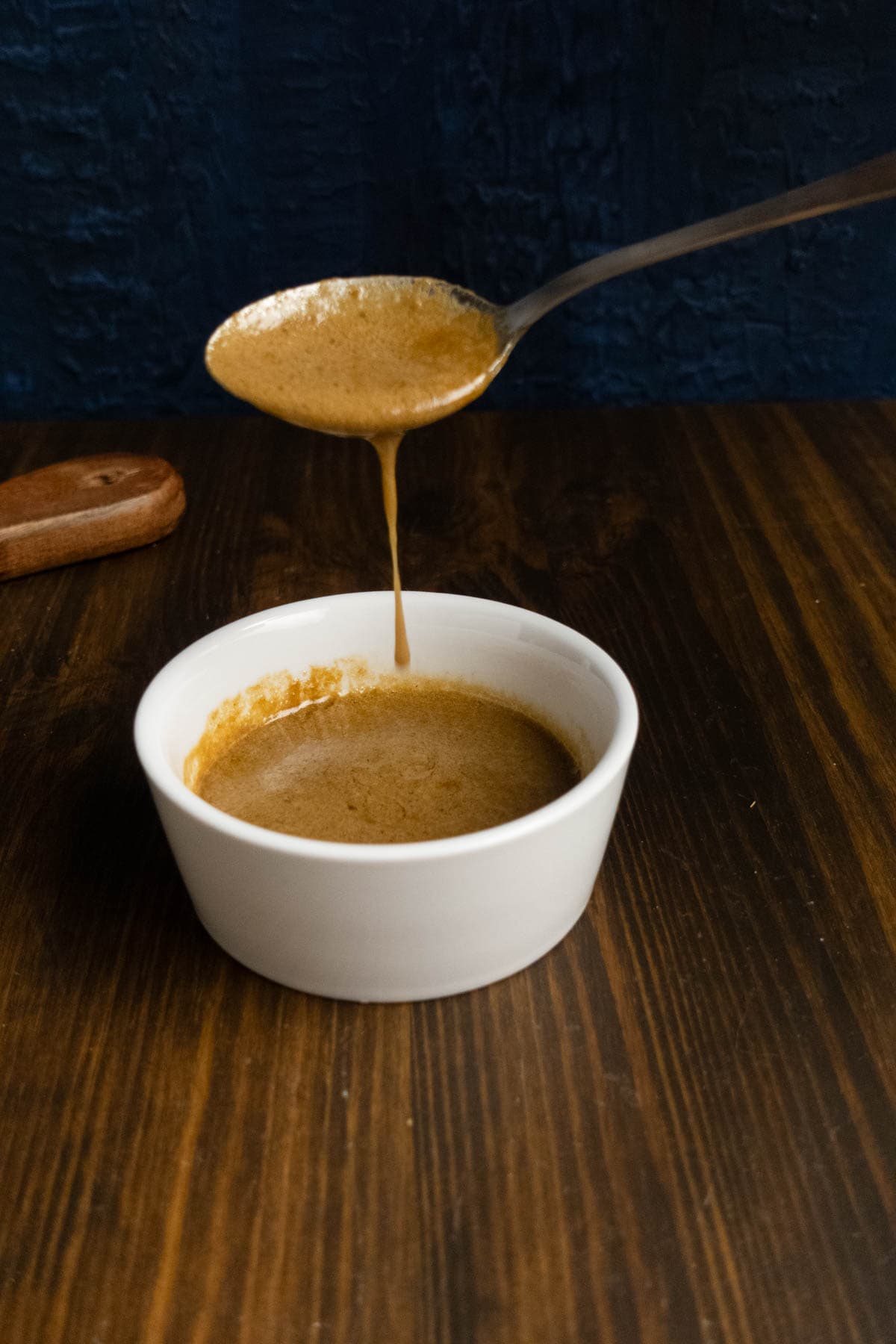 Finished black garlic sauce in a ramekin.