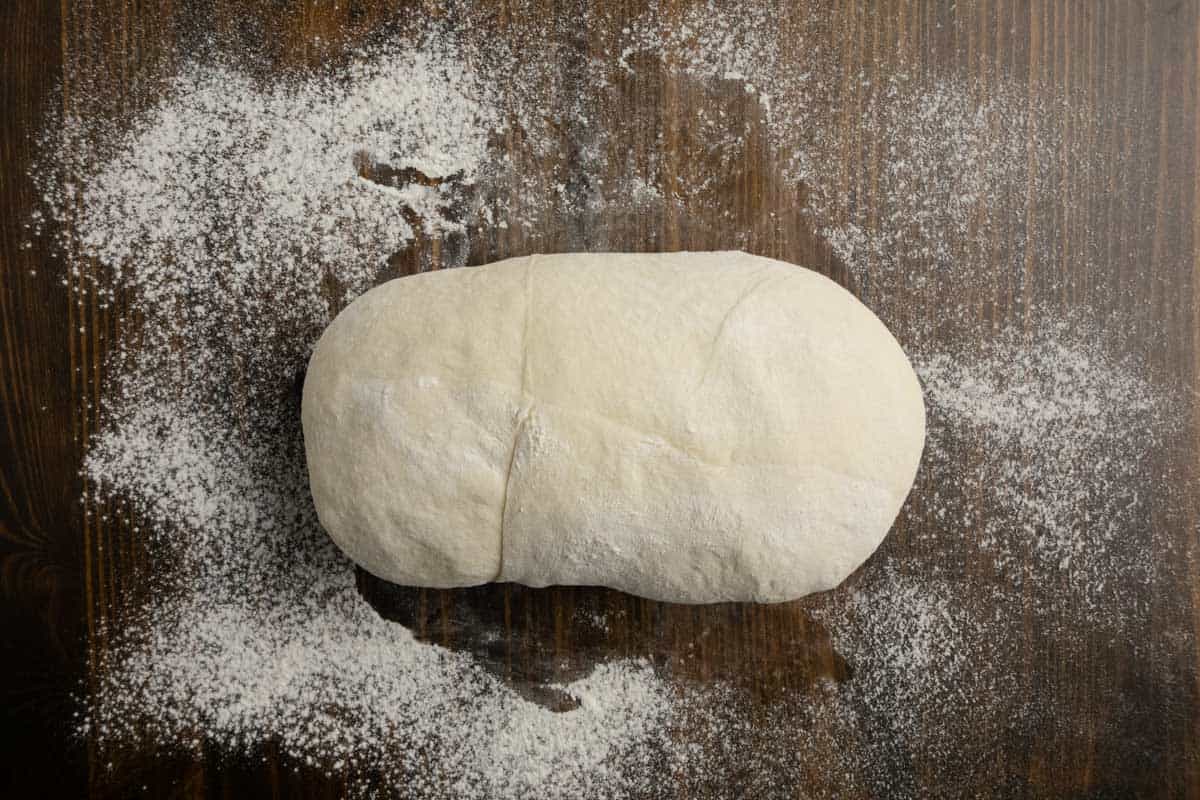 Ciabatta dough resting on a bench.