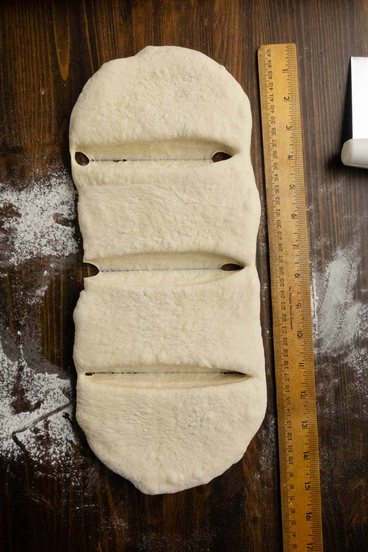 Ciabatta dough that has been cut every 4 inches.