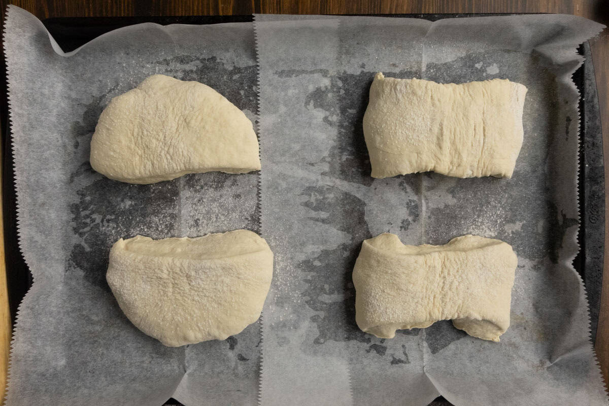 Shaped ciabatta rising on a baking sheet.
