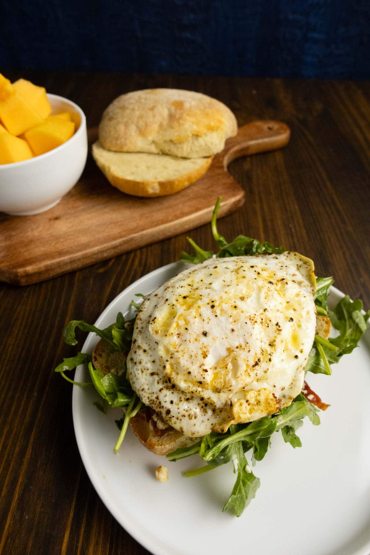 Ciabatta sandwich without the top bun so you can see the egg.