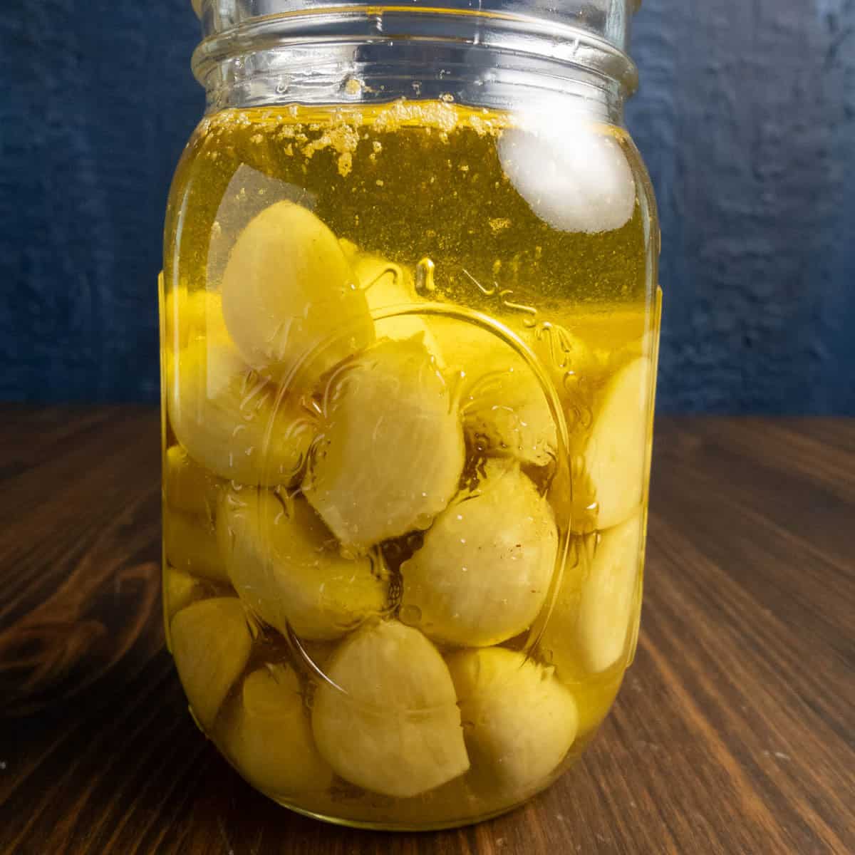 Finished garlic confit in a mason jar.