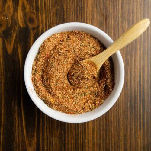 Spices all mixed together with a little wooden spoon.