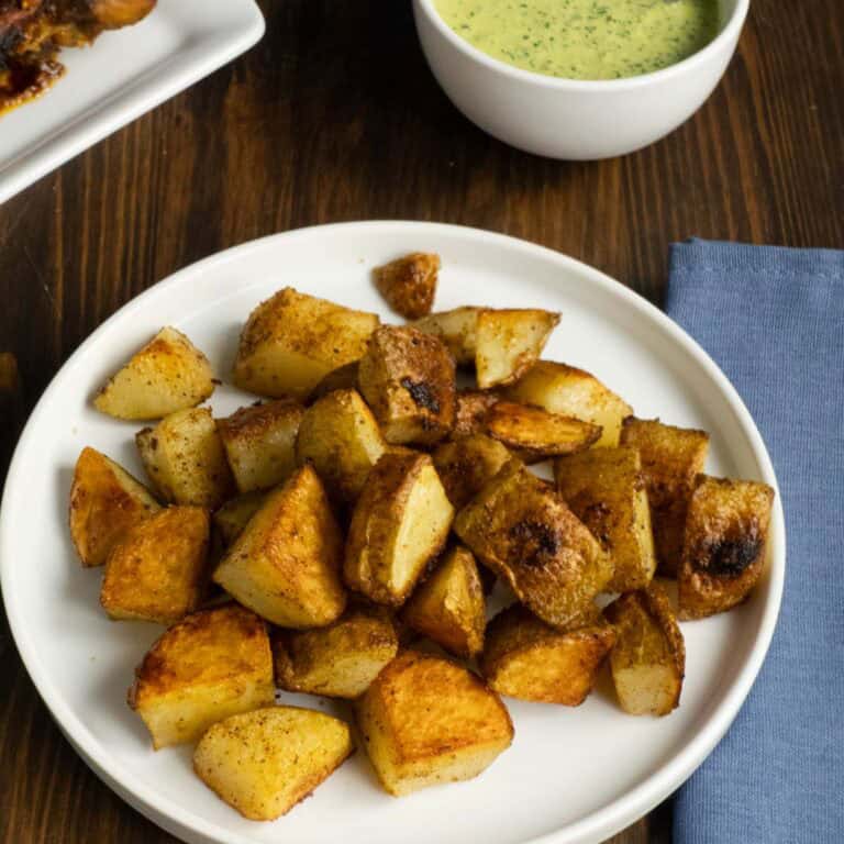 Extra Crispy Oven Roasted Potatoes without boiling on a plate.