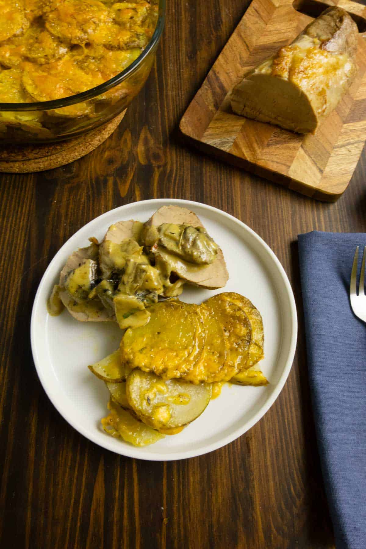 Potatoes gratin without cream on a plate with pork tenderloin.