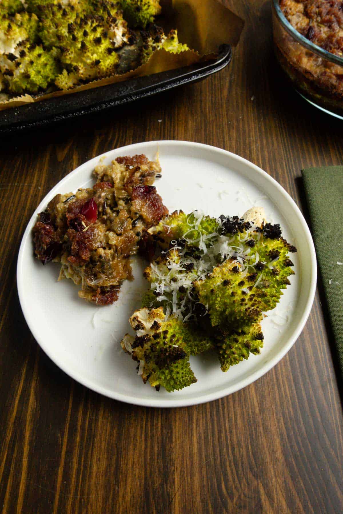 A plate of roasted Romanesco with a chicken and wild rice casserole with a cranberry topping.