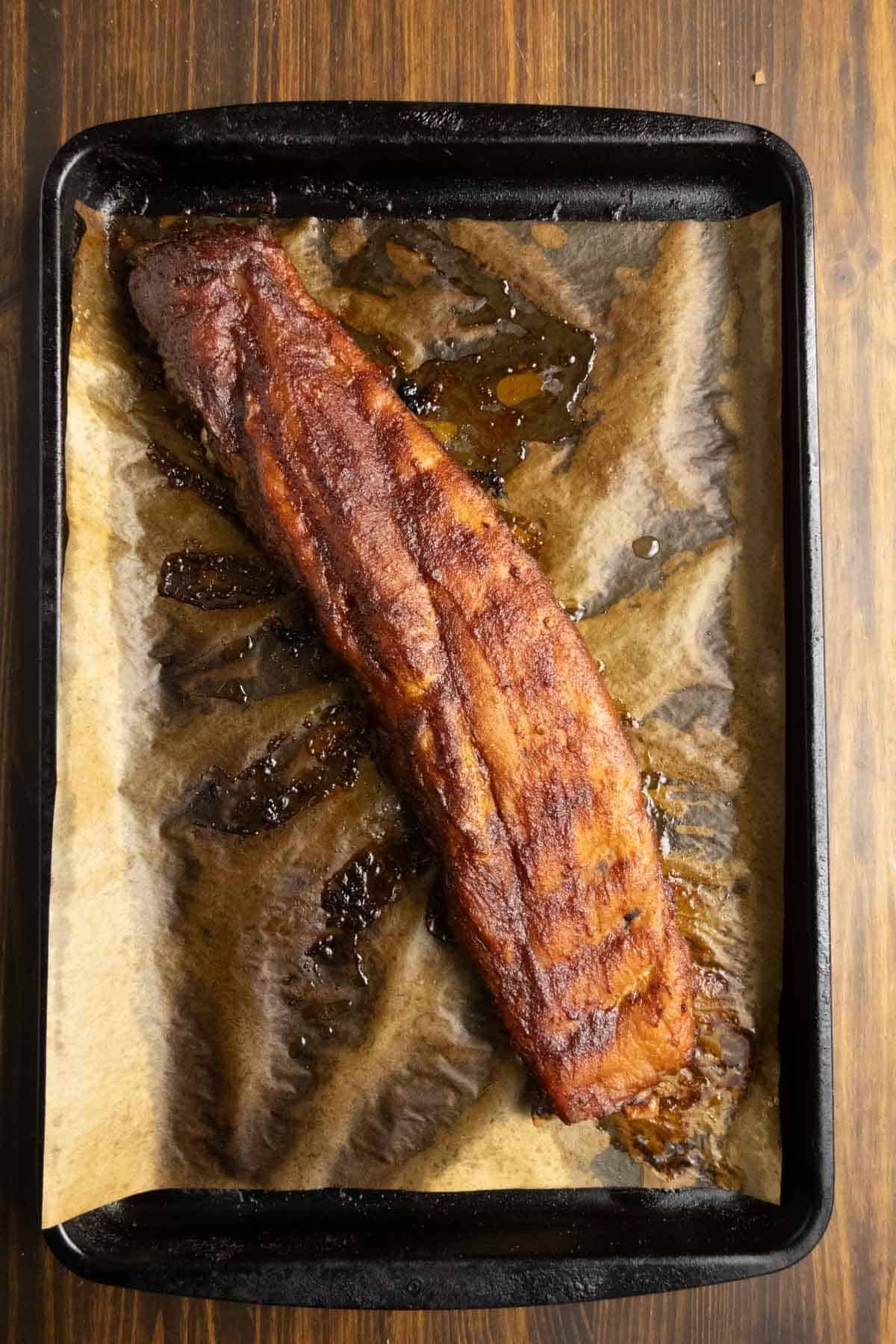 Whole rack of pork ribs with chipotle barbecue sauce on them.
