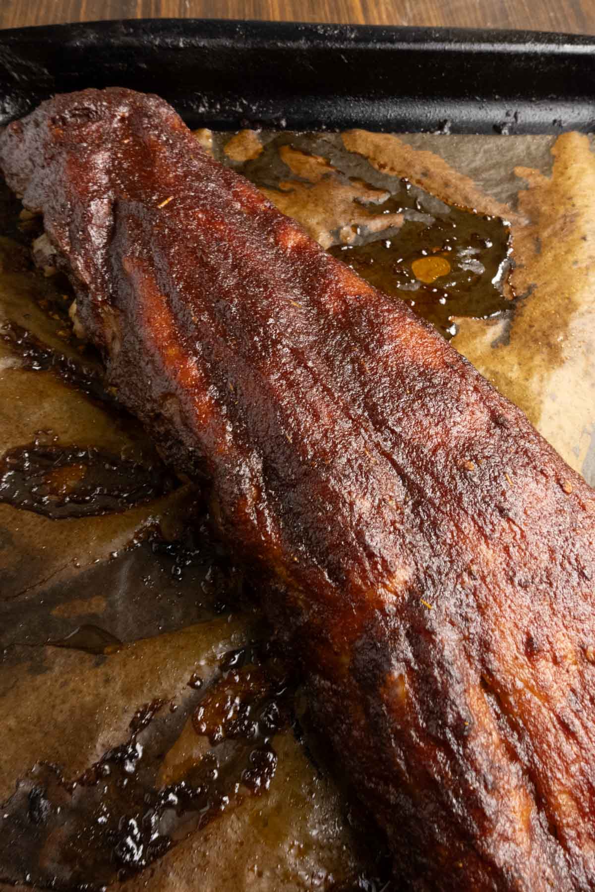 Close up on ribs after they've cooked and been sauced.