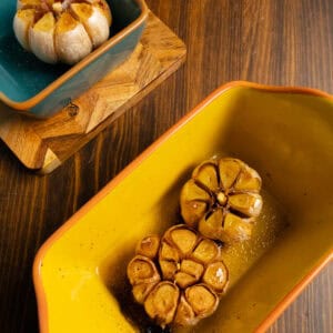 Roasted garlic bulbs in a pan.