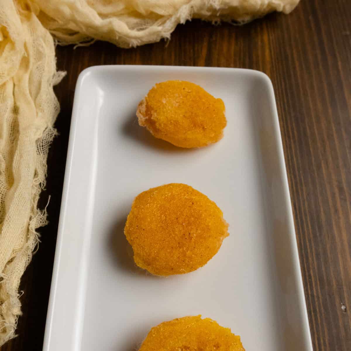 Finished salt cured egg yolks on a plate.