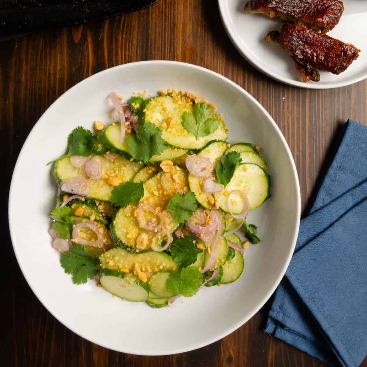 A bowl with Thai cucumber salad in it.